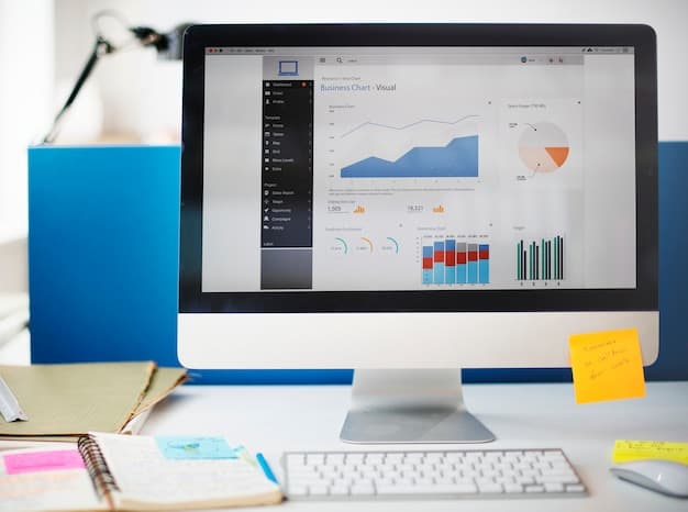 A professional office setup showing a desktop monitor with realistic business growth charts and analytics data